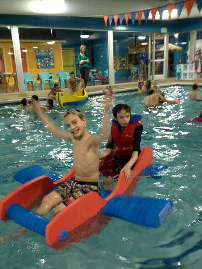kids swimming in Gold Fish Swim School Pool with Holly of Peak Potential Therapy