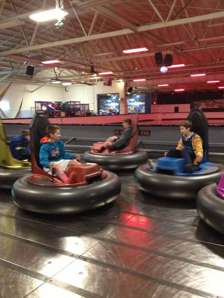 Kids riding indoor bumper cars at arcade