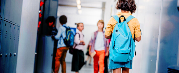 Girl Walking Down School Hallway