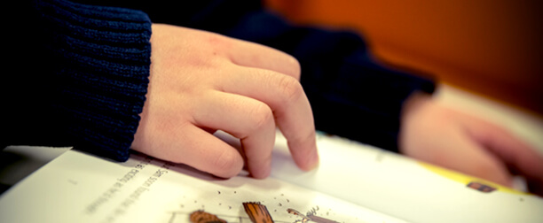 Hands Following Along in a Book