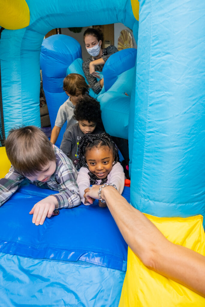 Children playing in a colorful bounce house.