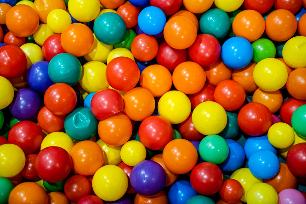 Colorful plastic balls scattered on a surface.