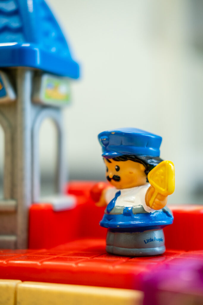 Toy police officer with ice cream scoop.