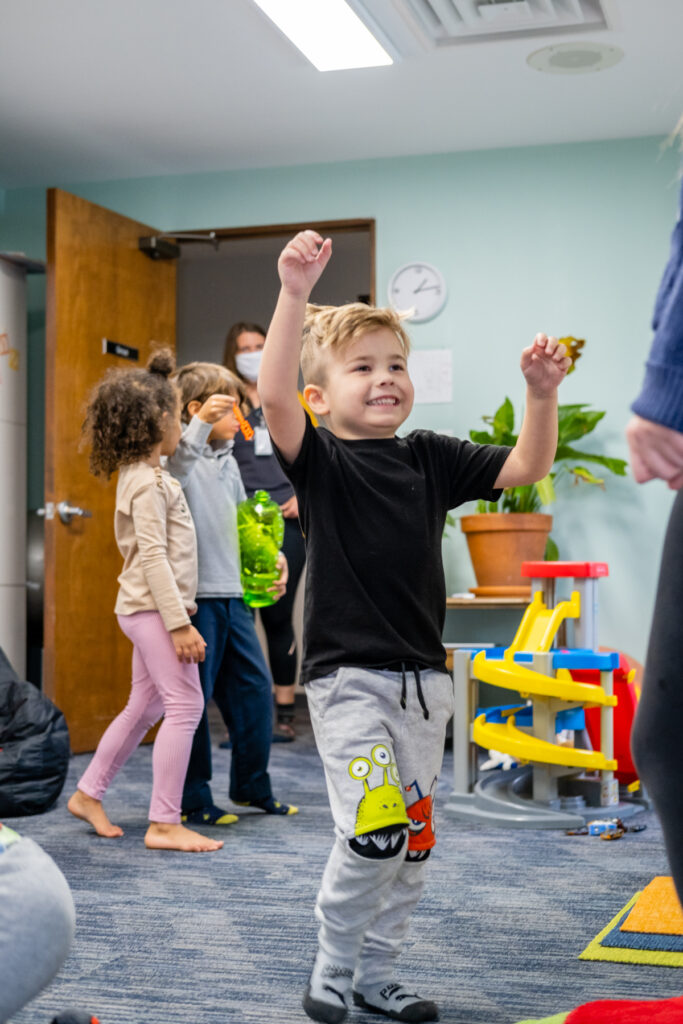 A boy with a black shirt playing with bubbles
