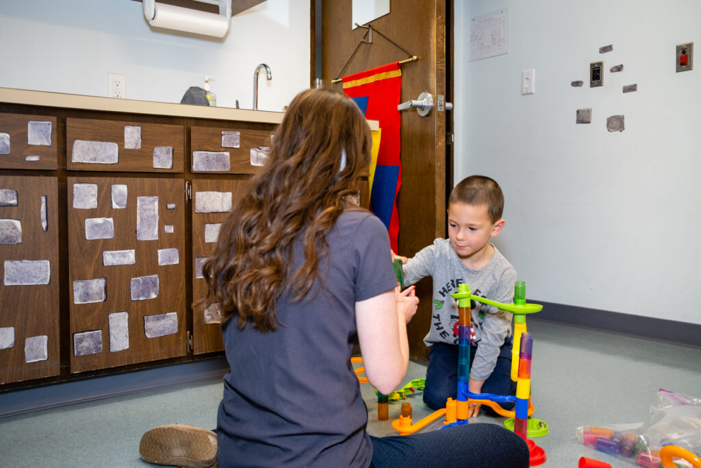 A woman with a kid playing